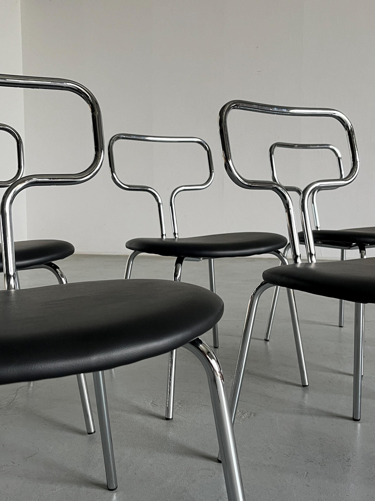 Curved Chrome Tubular Steel and Faux Leather Dining Chairs