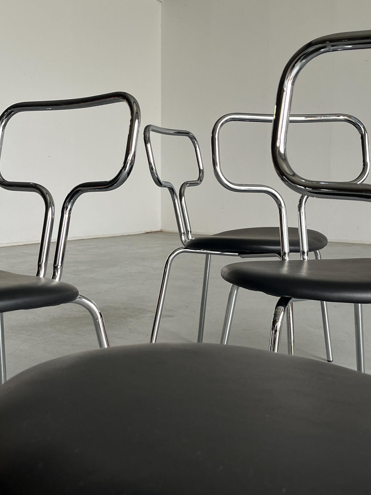 Curved Chrome Tubular Steel and Faux Leather Dining Chairs