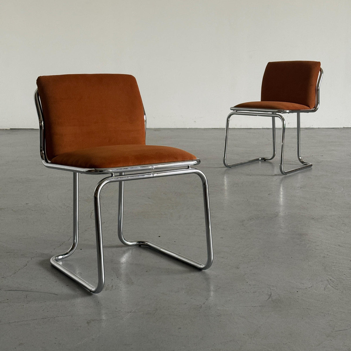 Chrome Loop Chairs with Rust Orange Upholstery