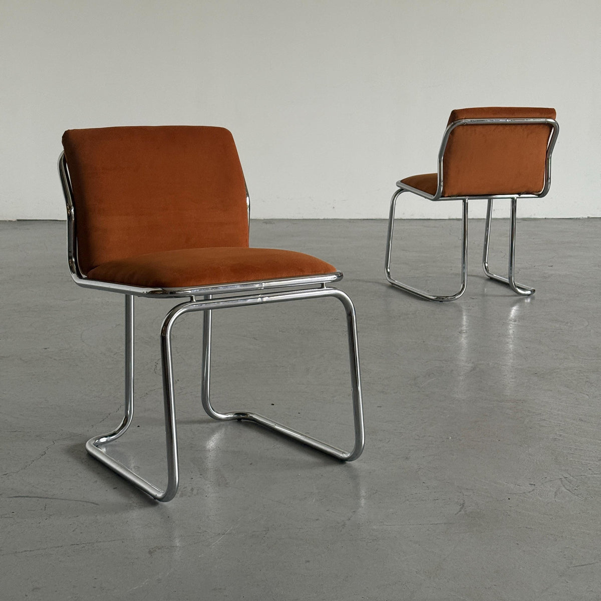 Chrome Loop Chairs with Rust Orange Upholstery