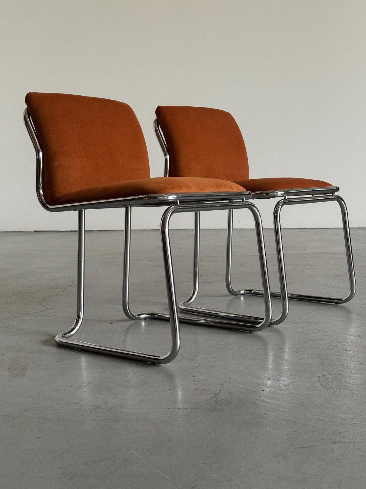 Chrome Loop Chairs with Rust Orange Upholstery