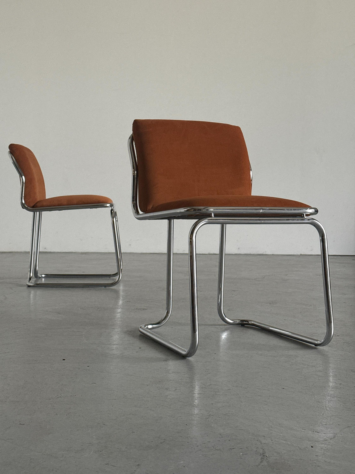 Chrome Loop Chairs with Rust Orange Upholstery