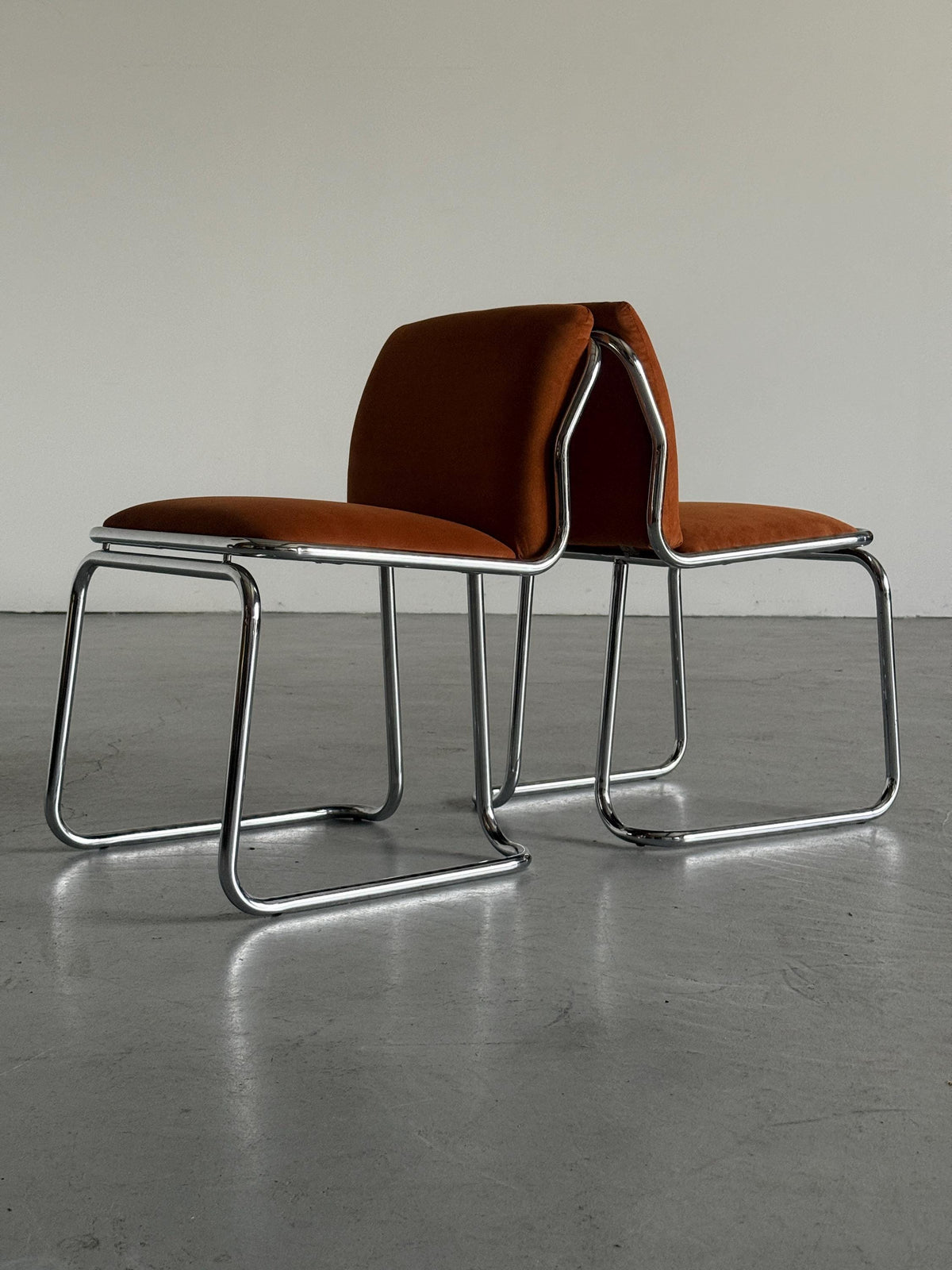 Chrome Loop Chairs with Rust Orange Upholstery