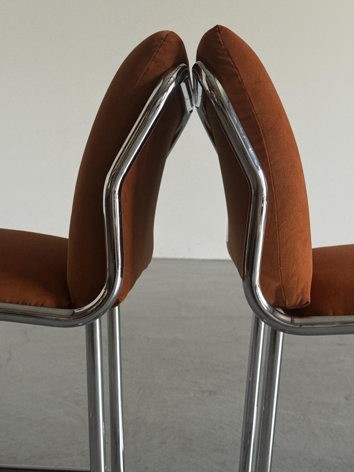 Chrome Loop Chairs with Rust Orange Upholstery