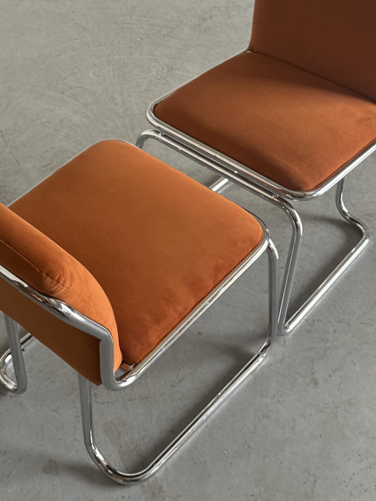 Chrome Loop Chairs with Rust Orange Upholstery