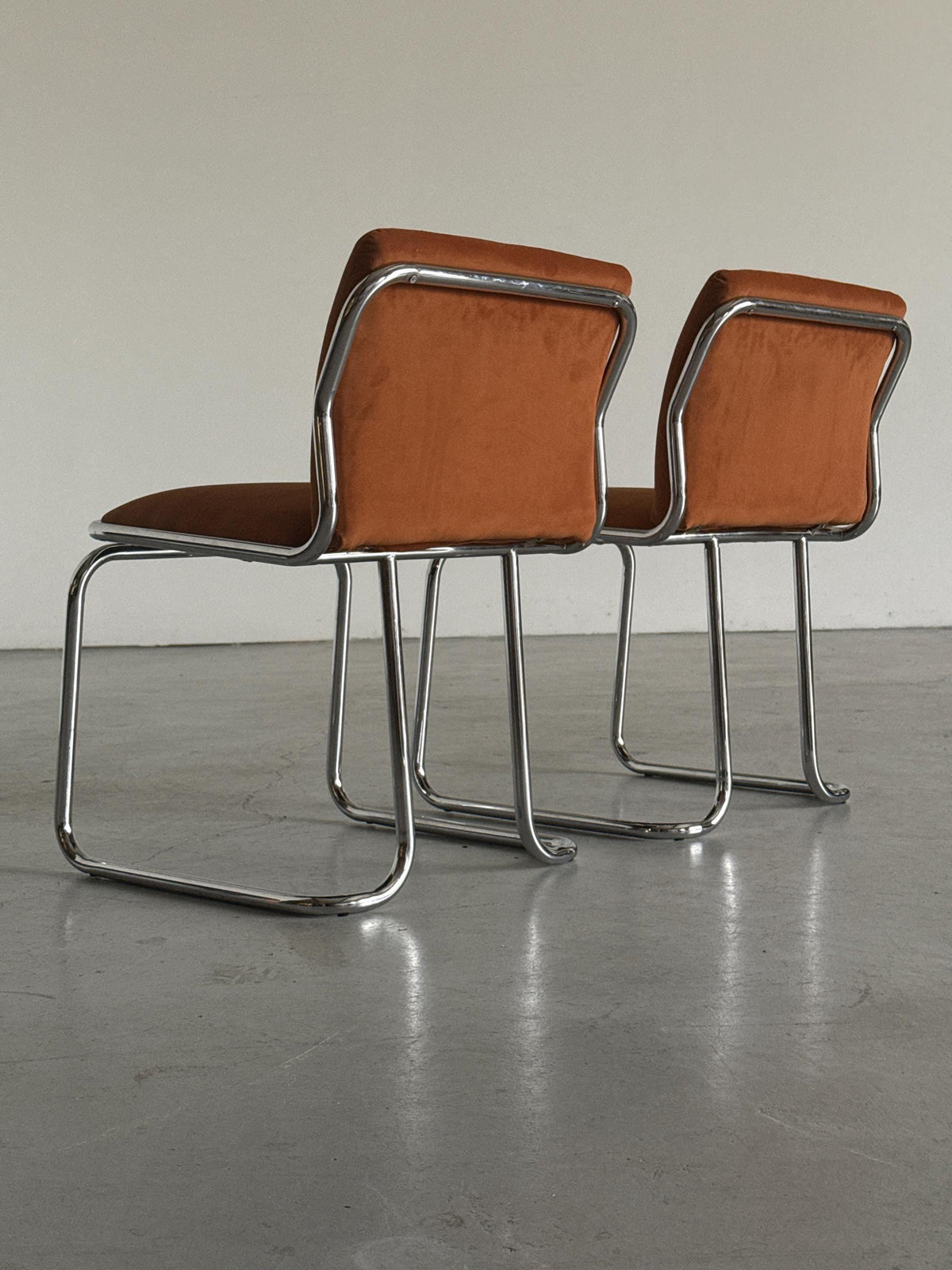 Chrome Loop Chairs with Rust Orange Upholstery