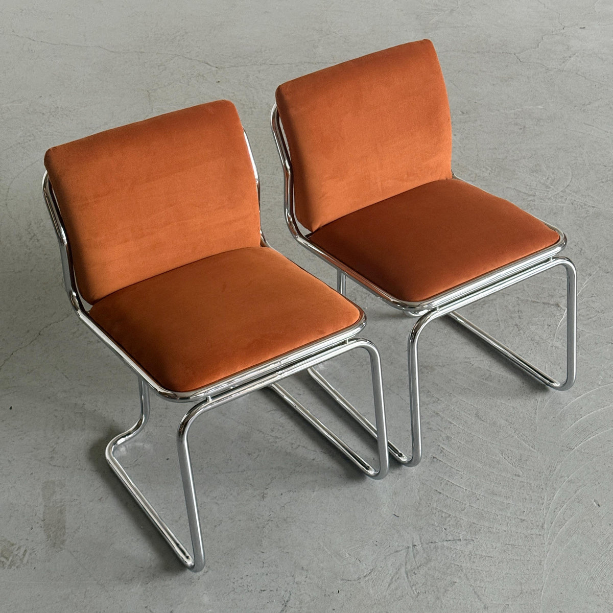 Chrome Loop Chairs with Rust Orange Upholstery