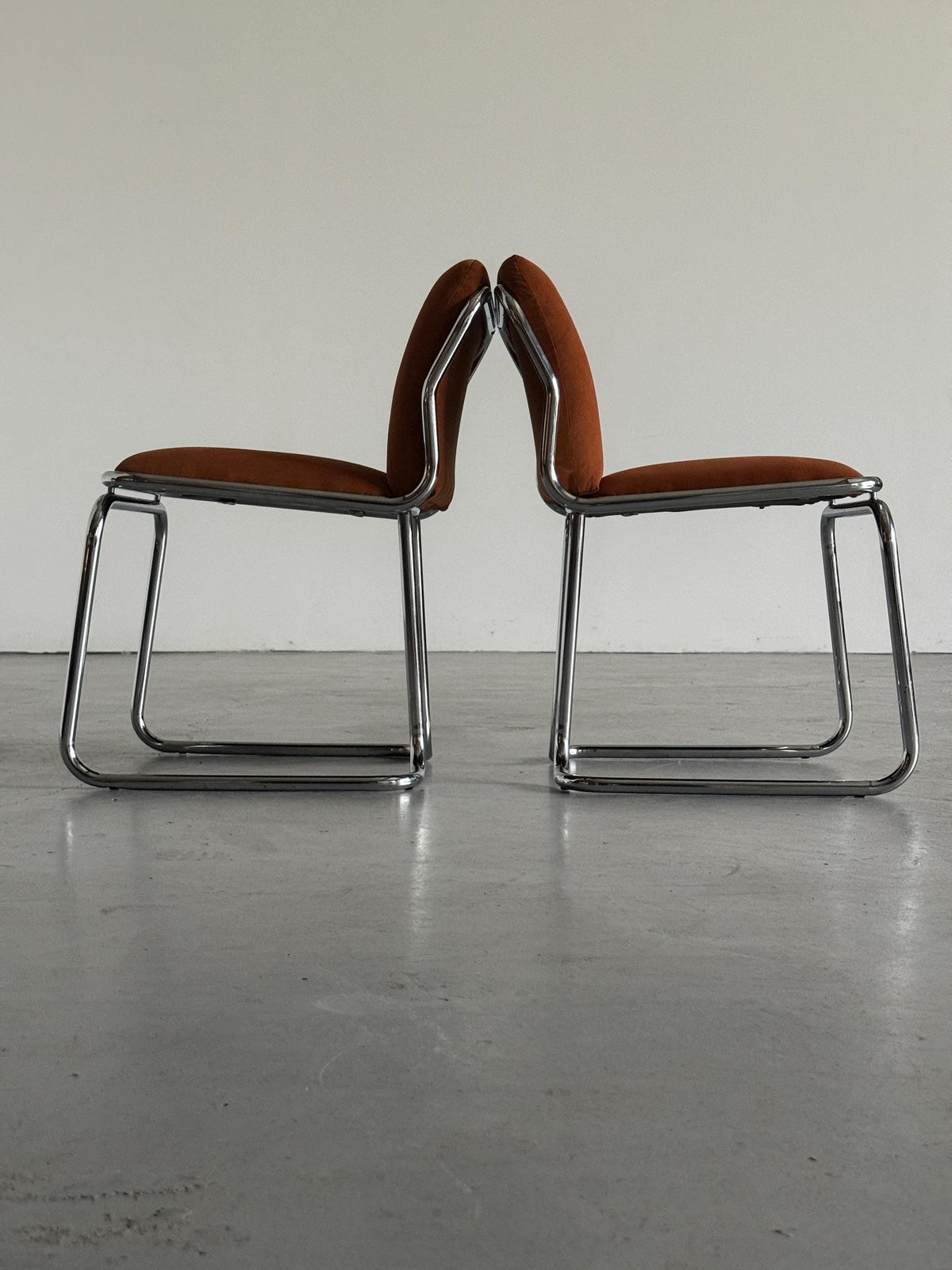 Chrome Loop Chairs with Rust Orange Upholstery