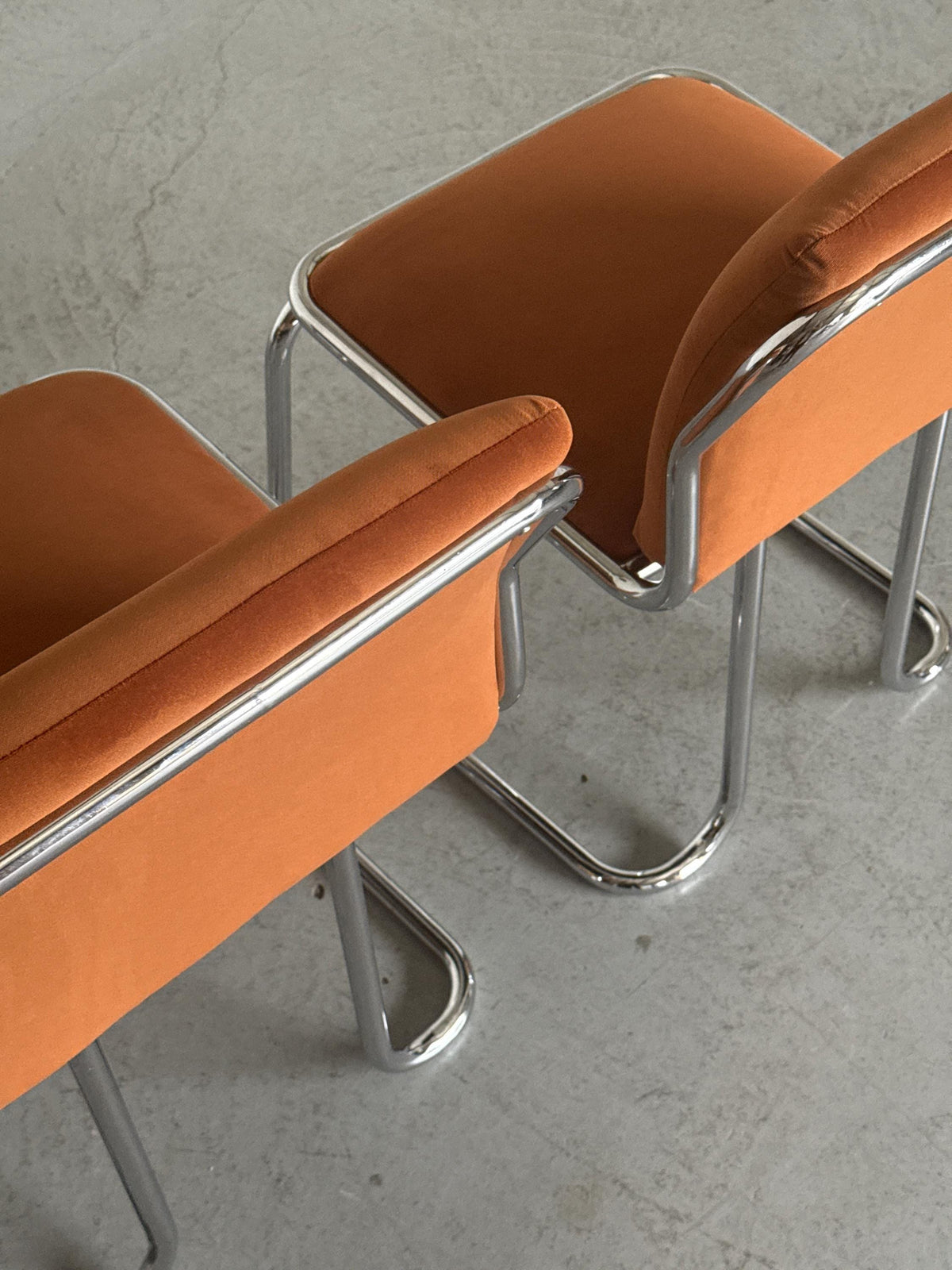 Chrome Loop Chairs with Rust Orange Upholstery