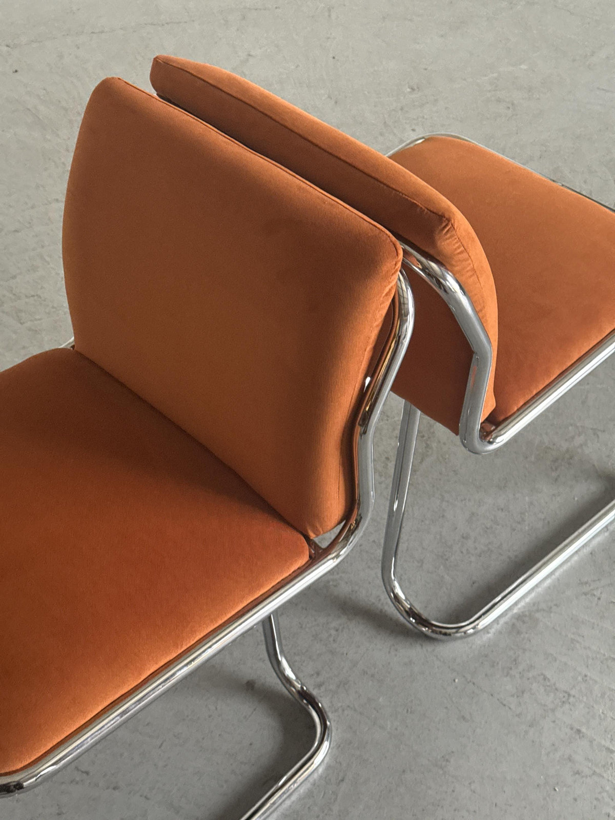 Chrome Loop Chairs with Rust Orange Upholstery