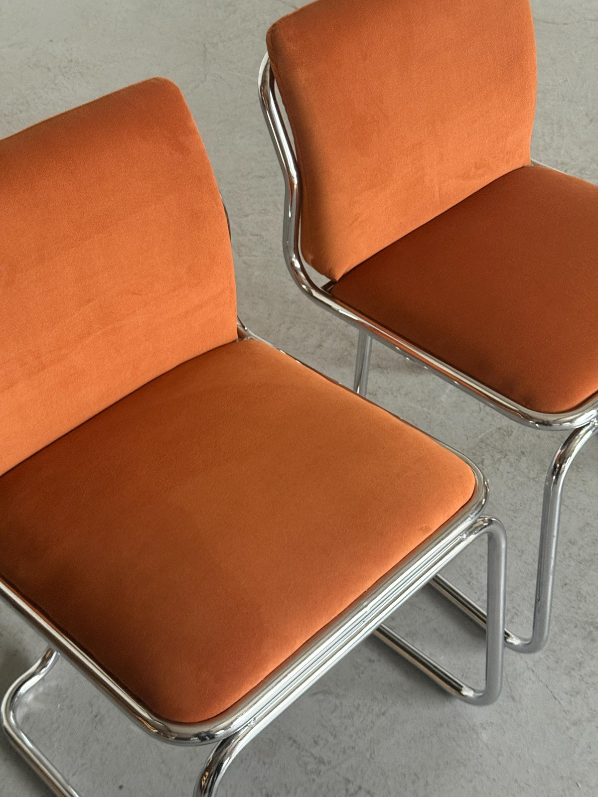 Chrome Loop Chairs with Rust Orange Upholstery
